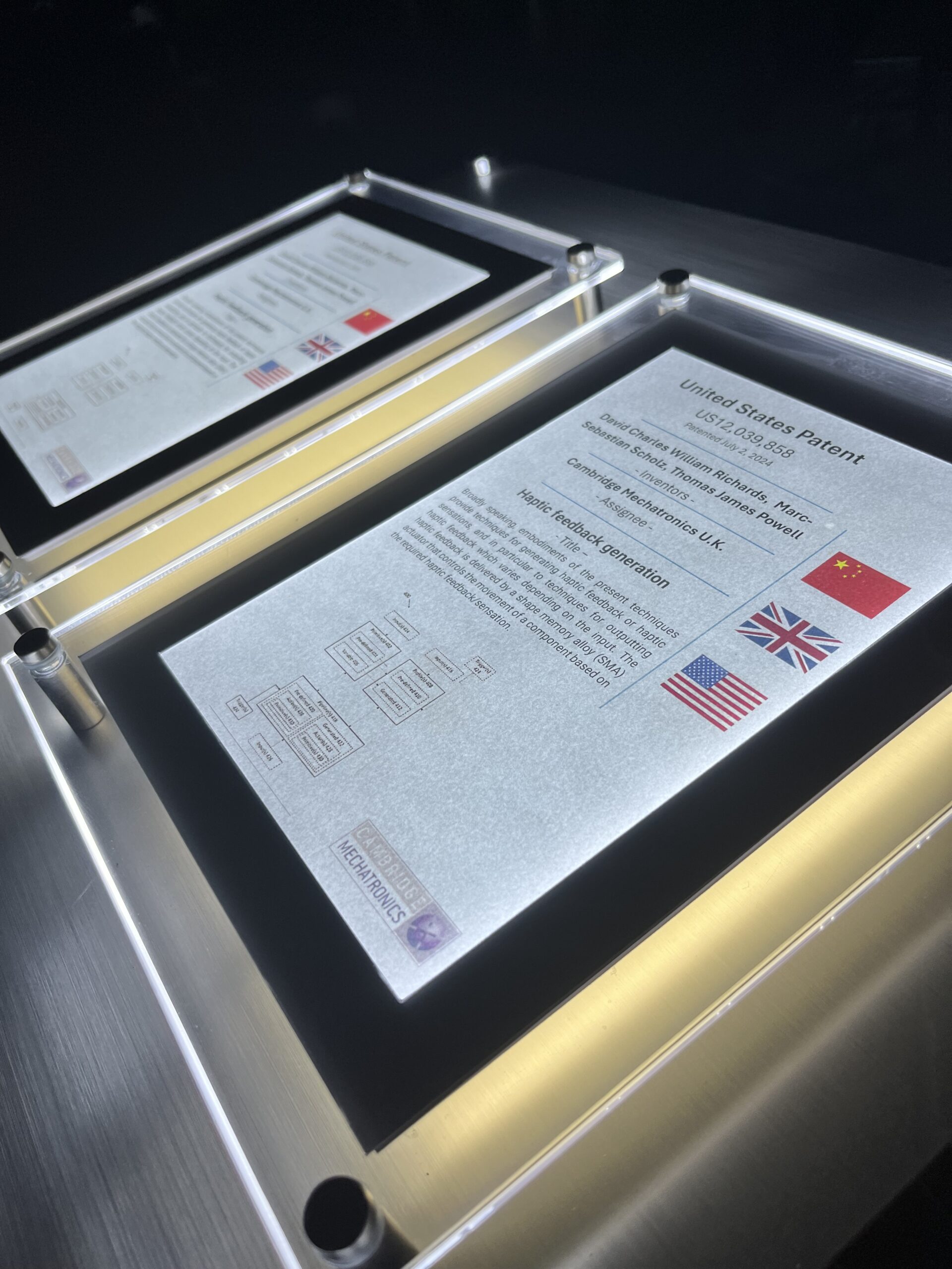 Display case with framed historical documents and certificates.