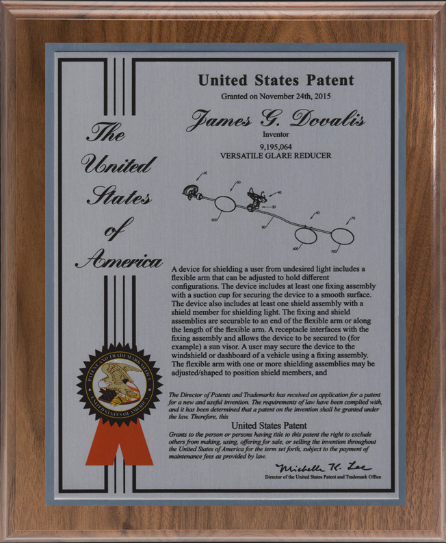 Framed United States patent document with a decorative seal and ribbon.