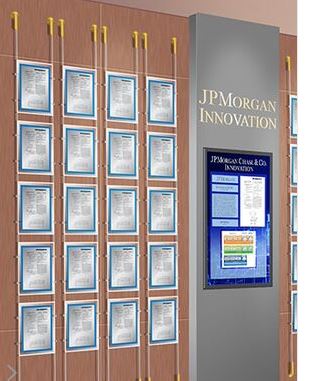 Wall display showcasing multiple certificates and a digital screen for JPMorgan Innovation.